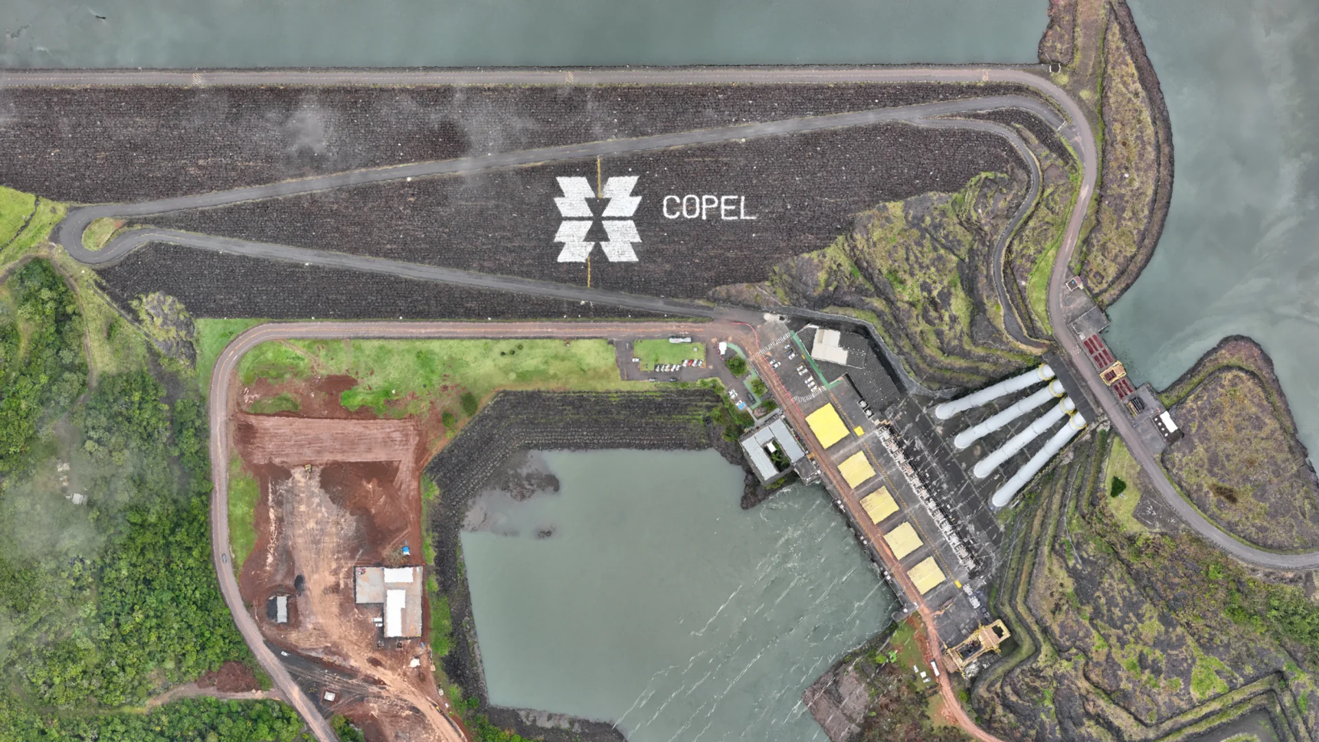 Reservoir dam and hydroelectric infrastructure · aerial site view